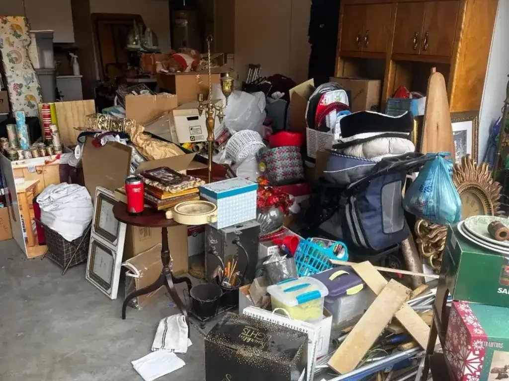 A garage packed with boxes furniture and household items