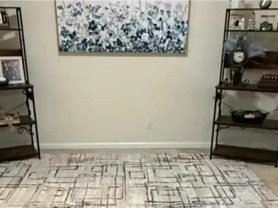 The same living room with the sofa and ottoman gone