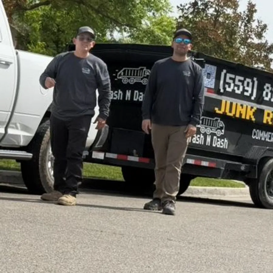 The Trash N Dash crew with the company truck and branded dump trailer