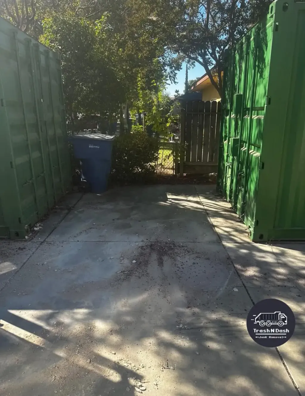 The same walkway beside the shipping containers, swept clear after pickup