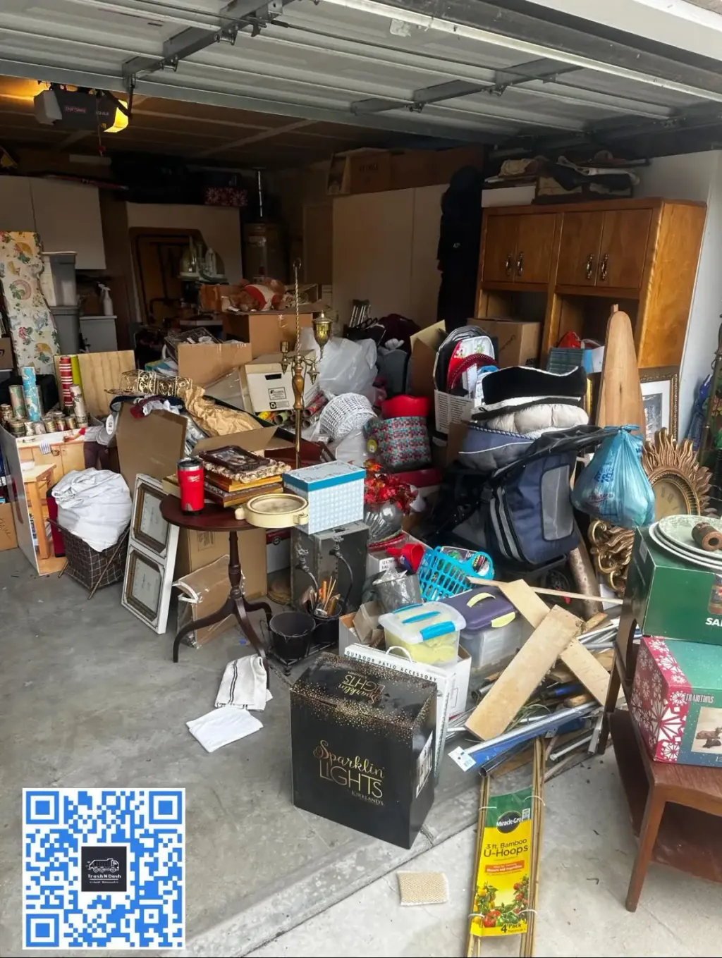 A garage packed wall to wall with furniture, boxes and household items