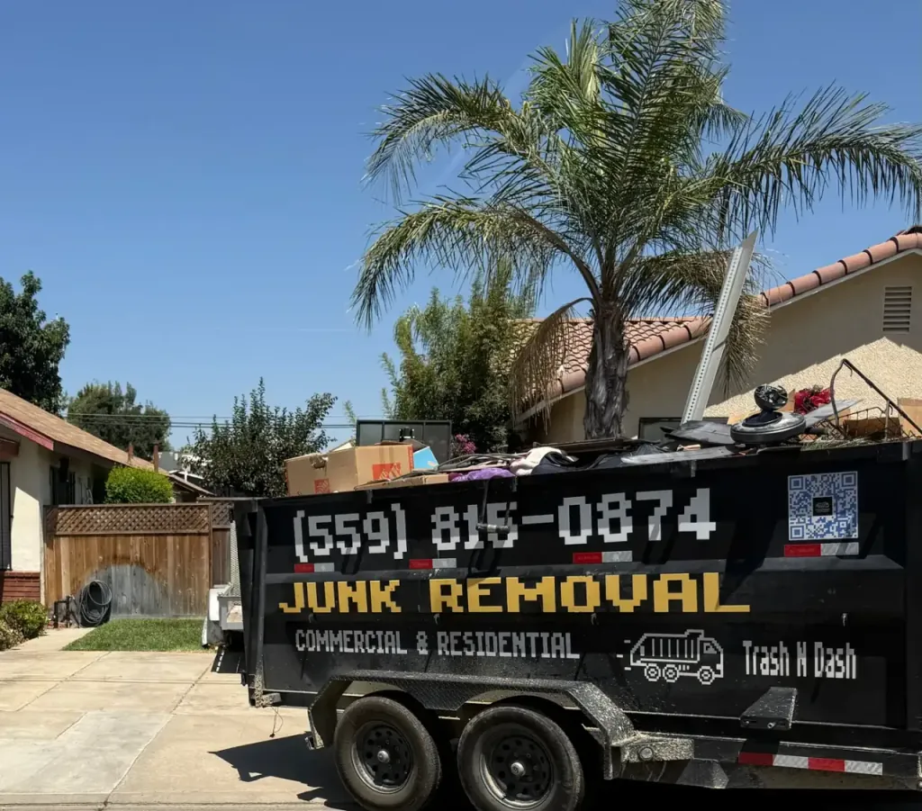 The Trash N Dash trailer loaded to the top on a residential street