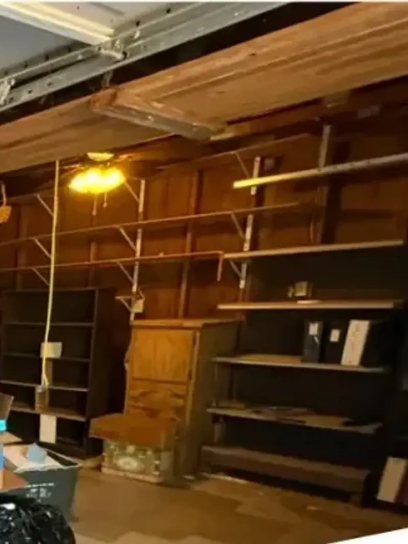 Wooden storage shelves packed with stored items and bags on the floor
