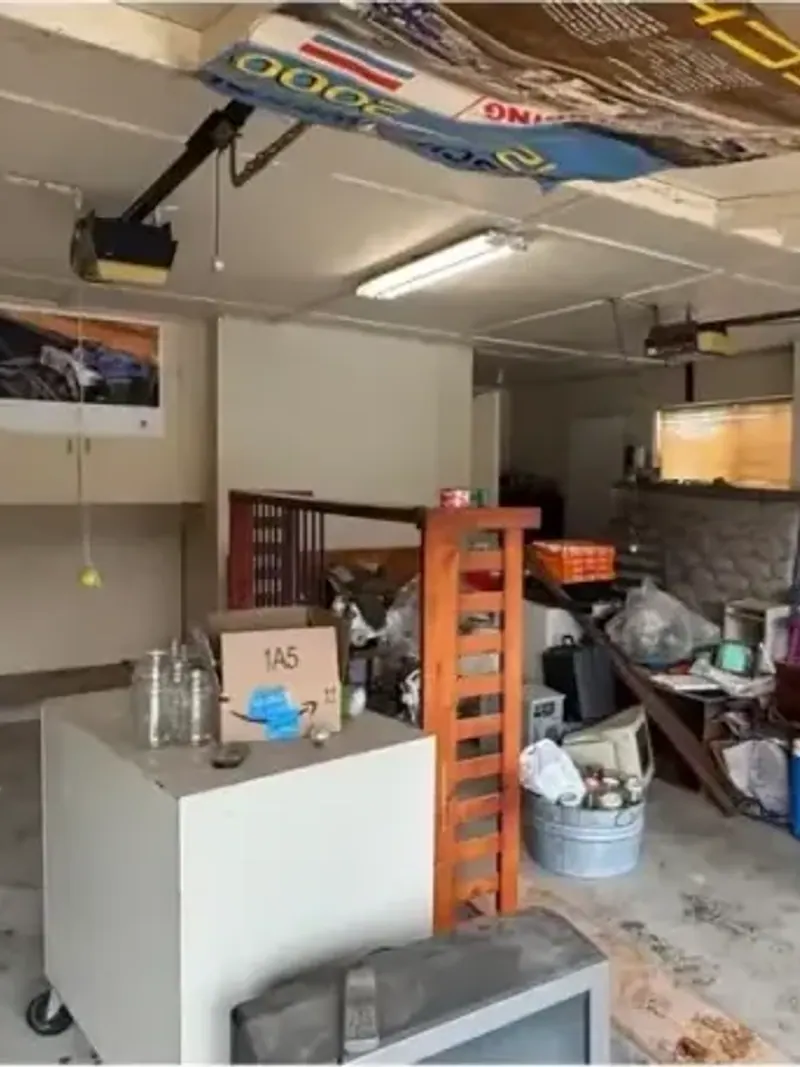 A rental garage with a bike a cabinet and stored items